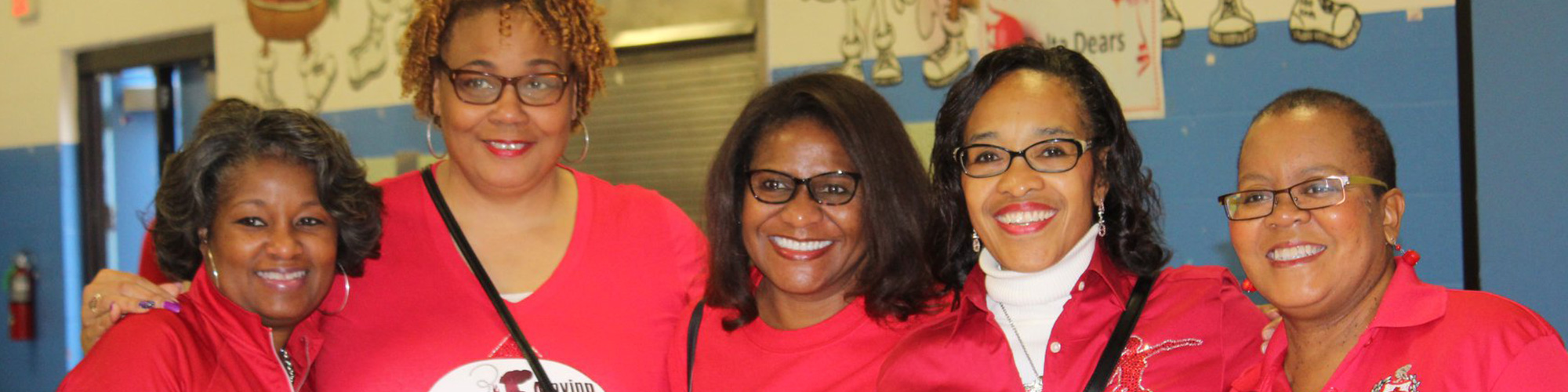 Five members smiling for a photo.